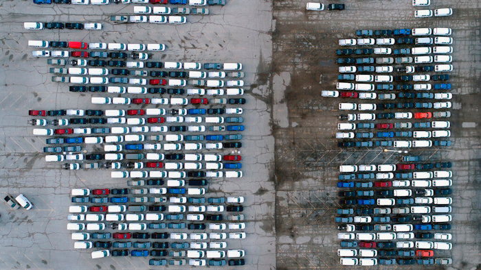 In this March 24 photo, mid-sized pickup trucks and full-size vans are seen in a parking lot outside a General Motors assembly plant where they are produced in Wentzville, Mo.