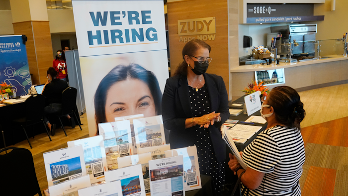 Marriott human resources recruiter Mariela Cuevas, left, talks to Lisbet Oliveros, during a job fair at Hard Rock Stadium, Friday, Sept. 3, 2021, in Miami Gardens, Fla.