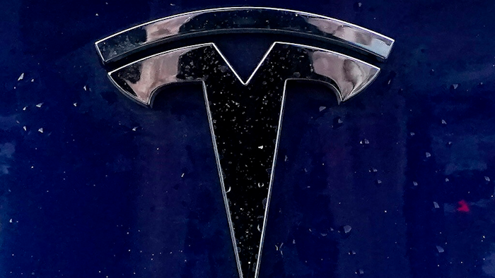 In this Feb. 21, 2021 file photo, a Tesla electric vehicle emblem is affixed to a passenger vehicle in Boston. The U.S. government’s highway safety agency wants detailed information on how Tesla’s Autopilot system detects and responds to emergency vehicles that are handling traffic crashes. The National Highway Traffic Safety Administration made the request in an 11-page letter to the electric car maker that was dated Tuesday, Aug. 31.