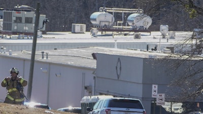 A Hall County firefighter leaves following a liquid nitrogen leak that killed six people at Prime Pak Foods, a poultry plant, on Jan. 28 in Gainesville, GA.