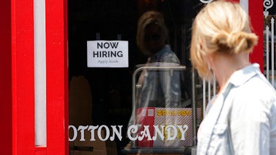 A 'NOW HIRING' sign is posted in the window of The Wharf Chocolate Factory at Fisherman's Wharf in Monterey, Calif. on Aug. 6.