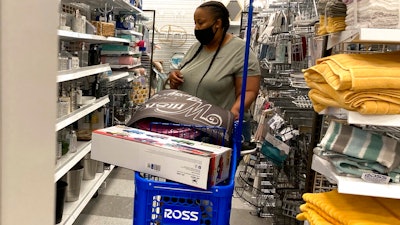 In this July 21, 2021 photo, a consumer shops as she wears a mask at a retail store in Morton Grove, Ill.