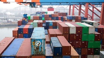 In this March 22, 2019 photo, containers are unloaded by a freighter at the Eurokai terminal (Eurogate) in the port of Hamburg, Germany.