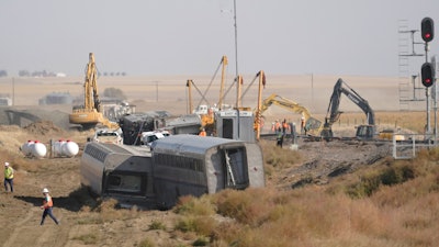 Overturned passenger railcars sit beside train tracks near Joplin, Mont., Sept. 27, 2021.