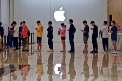 People line up at an Apple Store to buy the latest iPhone 13 handsets in Nanning in south China's Guangxi Zhuang Autonomous Region on Sept. 24, 2021. Global shoppers face possible shortages of smartphones and other goods ahead of Christmas after power cuts to meet government energy use targets forced Chinese factories to shut down and left some households in the dark.
