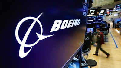 The logo for Boeing appears on a screen above a trading post on the floor of the New York Stock Exchange, Tuesday, July 13, 2021. Despite the pandemic's damage to air travel, Boeing says it's optimistic about long-term demand for airplanes. Boeing said Tuesday, Sept. 14, 2021 that it expects the aerospace market to be worth $9 trillion over the next decade. That includes planes for airlines and military uses and other aerospace products and services.