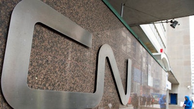 In this May 13, 2021, file photo, a man walks into Central Station next to Canadian National headquarters in Montreal. Canadian National’s $33.6 billion deal to acquire Kansas City Southern railroad is in jeopardy after federal regulators rejected a key part of the plan Tuesday, Aug. 31, 2021 and opened the door for a competing $31 billion offer from Canadian Pacific railroad.