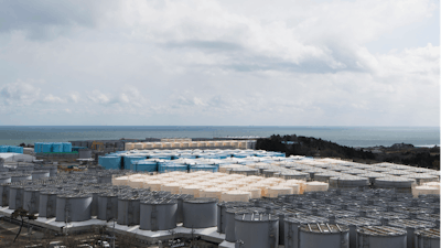 In this Feb. 27, 2021, file photo, tanks (in gray, beige and blue) store water that was treated but is still radioactive after it was used to cool down spent fuel at the Fukushima Daiichi nuclear power plant in Okuma town, Fukushima prefecture, northeastern Japan.