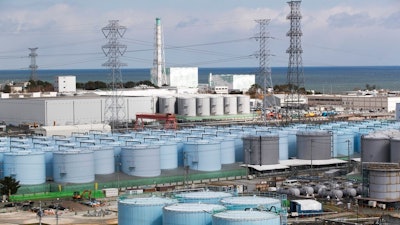In this Saturday, Feb. 27, 2021, file photo, Nuclear reactors of No. 5, center left, and 6 look over tanks storing water that was treated but still radioactive, at the Fukushima Daiichi nuclear power plant in Okuma town, Fukushima prefecture, northeastern Japan.