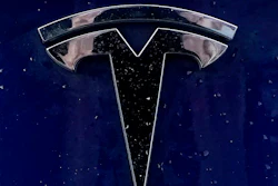 In this Feb. 21, 2021 file photo, a Tesla electric vehicle emblem is affixed to a passenger vehicle in Boston. The U.S. government’s highway safety agency wants detailed information on how Tesla’s Autopilot system detects and responds to emergency vehicles that are handling traffic crashes. The National Highway Traffic Safety Administration made the request in an 11-page letter to the electric car maker that was dated Tuesday, Aug. 31.