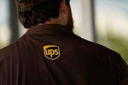 A UPS logo is on the shirt of a driver as he enters a United Parcel Service store with packages in Jackson, Miss., Monday, July 26, 2021. The Atlanta-based company said Thursday, Sept. 9, that it plans to hire more than 100,000 people for the busy holiday shipping season, many of whom will get job offers within 30-minutes of applying. UPS needs to snap up workers as fast as it can because of the tight job market.