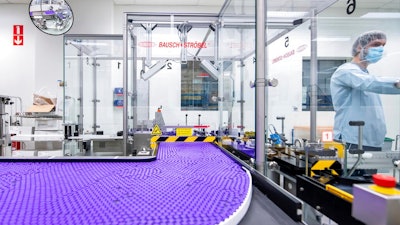 In this March 2021 photo provided by Pfizer, a technician works on a line for packaging preparation for the Pfizer-BioNTech COVID-19 vaccine at the company's facility in Puurs, Belgium. Billions more in profits are at stake for some vaccine makers as the U.S. moves toward dispensing COVID-19 booster shots to shore up Americans' protection against the virus.