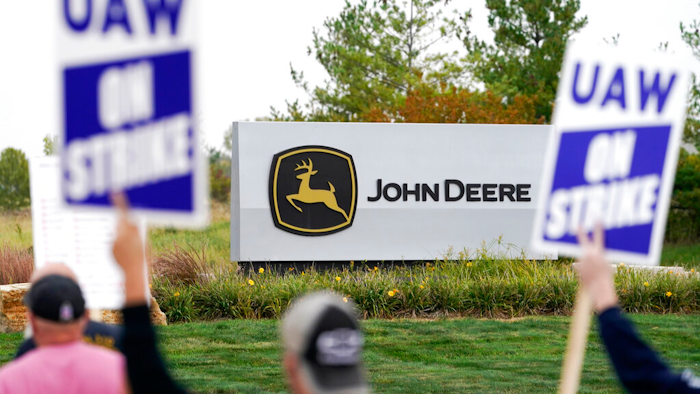 Members of the United Auto Workers strike outside of a John Deere plant on Oct. 20, 2021, in Ankeny, Iowa.