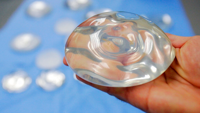 In this Dec. 11, 2006 file photo, a silicone gel breast implant is shown at Mentor Corp., a subsidiary of Johnson & Johnson, in Irving, Texas. On Wednesday, Oct. 27, 2021, U.S. health regulators finalized stronger warnings for breast implants, including a new requirement that people receive detailed information about their potential risks and complications before getting them.