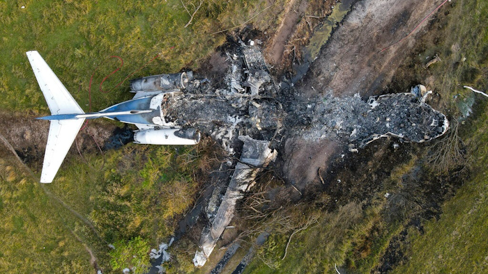The remnants of an aircraft, which caught fire soon after a failed take-off attempt at Houston Executive Airport, are seen just north of Morton Road on Tuesday, Oct. 19, 2021, in Brookshire. Texas.