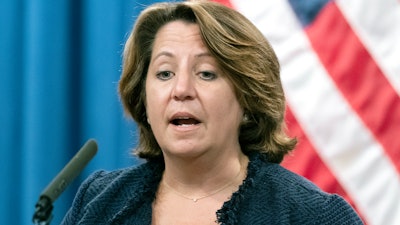 In this Sept. 30, 2021 photo, Deputy Attorney General Lisa Monaco speaks with reporters during a news conference at the Department of Justice in Washington. Monaco said the Justice Department, as part of a new initiative, is prepared to take legal action under a statute called the False Claims Act against contractors who misuse federal dollars by failing to disclose hacks or by having deficient cybersecurity standards. The department will also protect whistleblowers who come forward to report those issues.