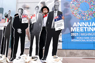 Activists holding a cardboard cutouts of President Joe Biden, Canadian Prime Minister Justin Trudeau, Australian Prime Minister Scott Morrison, Britain's Prime Minister Boris Johnson and Italian Prime Minister Mario Draghi protest outside of the International Monetary Fund headquarters during the World Bank/IMF Annual Meetings in Washington on Oct. 13, 2021.
