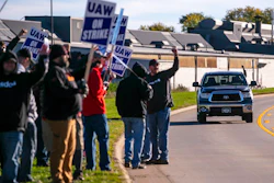 John Deere Drivetrain Operations workers in Waterloo, Iowa, cheer on the picket line as passing cars honk in support as the UAW officially started its strike on Oct. 14, 2021.