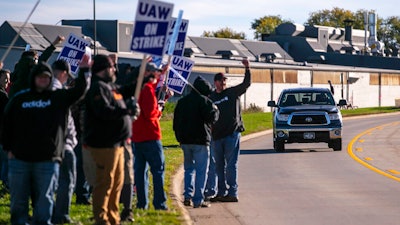John Deere Drivetrain Operations workers in Waterloo, Iowa, cheer on the picket line as passing cars honk in support as the UAW officially started its strike on Oct. 14, 2021.