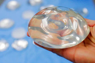 In this Dec. 11, 2006 file photo, a silicone gel breast implant is shown at Mentor Corp., a subsidiary of Johnson & Johnson, in Irving, Texas. On Wednesday, Oct. 27, 2021, U.S. health regulators finalized stronger warnings for breast implants, including a new requirement that people receive detailed information about their potential risks and complications before getting them.