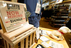 A now hiring sign sits on a display in a clothing store Saturday, Oct. 9, 2021, in Sioux Falls, S.D. The number of Americans applying for unemployment benefits fell to its lowest level since the pandemic began, a sign the job market is still improving even as hiring has slowed in the past two months.