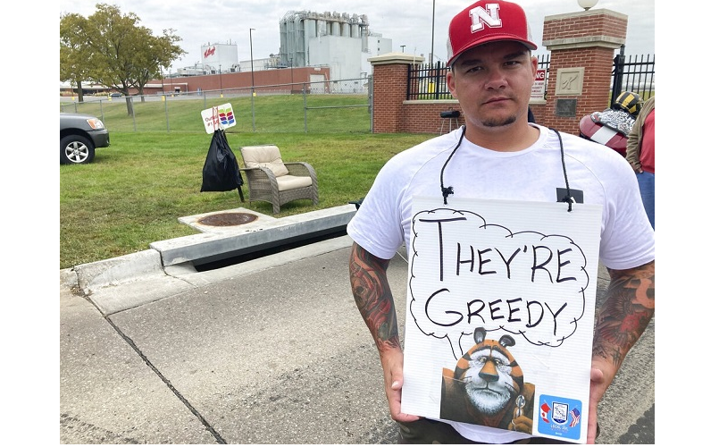 Michael Shlee, a bulk unloader at a Kellogg's cereal plant, pickets outside the facility's main entrance on Wednesday, Oct. 6, 2021, in Omaha, Neb. Workers have gone on strike after a breakdown in contract talks with company management.