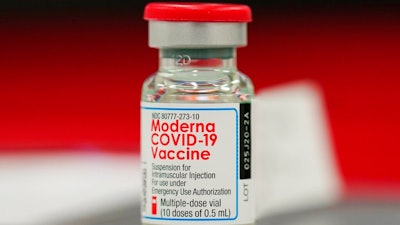This Wednesday, Dec. 23, 2020 file photo shows a vial of the Moderna COVID-19 vaccine in the first round of staff vaccinations at a hospital in Denver. On Thursday, Oct. 14, 2021, U.S. health advisers said that some Americans who received Moderna’s COVID-19 vaccine should get a half-dose booster to bolster protection against the virus.