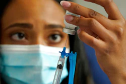 In this May 19, 2021, file photo, a licensed practical nurse draws a Moderna COVID-19 vaccine into a syringe at a mass vaccination clinic at Gillette Stadium in Foxborough, Mass. Starting Thursday, Oct. 14, 2021, the Food and Drug Administration convenes its independent advisers for the first stage in the process of deciding whether extra shots of Moderna or Johnson & Johnson vaccines should be dispensed and, if so, who should get them and when.