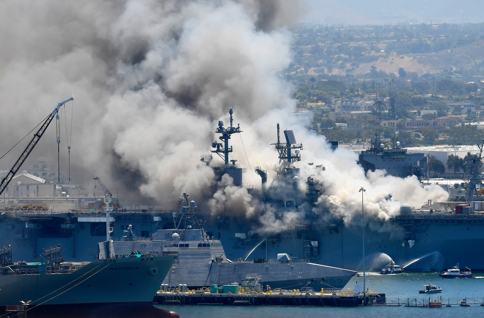 In this July 12, 2020, file photo, smoke rises from the USS Bonhomme Richard at Naval Base San Diego in San Diego, after an explosion and fire on board the ship at Naval Base San Diego. A Navy report has concluded there were sweeping failures by commanders, crew members and others that fueled the July 2020 arson fire that destroyed the USS Bonhomme Richard, calling the massive five-day blaze in San Diego preventable and unacceptable.