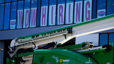 A hiring sign is displayed at a furniture store window on Friday, Sept. 17, 2021, in Downers Grove, Ill. Unemployment claims dropped 6,000 to 290,000 last week, the third straight drop, the Labor Department said Thursday, Oct. 21, 2021,. That’s the fewest people to apply for benefits since March 14, 2020, when the pandemic intensified.