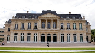 In this June 7, 2017 file photo, the Organisation for Economic Co-operation and Development (OECD) headquarters is pictured in Paris, France. Nearly 140 countries have agreed on a tentative deal that would make sweeping changes to how big, multinational companies are taxed in order to deter them from stashing their profits in offshore tax havens where they pay little or no tax. The agreement announced Friday foresees countries enacting a global minimum corporate tax of 15% on the biggest, internationally active companies.