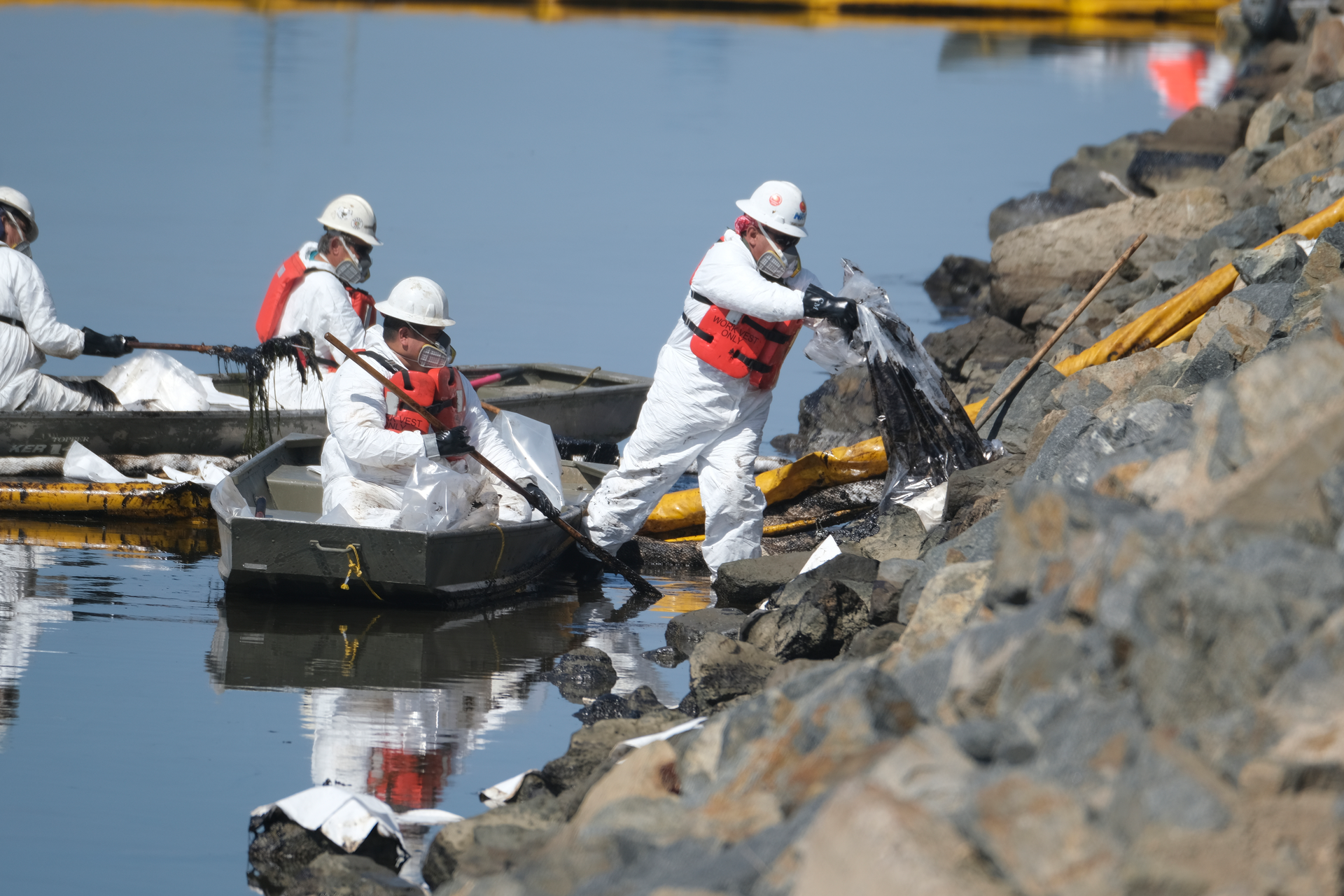 Cleanup contractors unload collected oil in plastic bags trying to stop further oil crude incursion into the Wetlands Talbert Marsh in Huntington Beach, Calif., Sunday, Oct. 3, 2021. One of the largest oil spills in recent Southern California history fouled popular beaches and killed wildlife while crews scrambled Sunday to contain the crude before it spread further into protected wetlands.