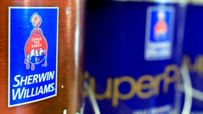 In this Oct. 20, 2010, file photo, cans of paint are seen at a Sherwin Williams store in Brunswick, Maine. Sherwin-Williams is one of a number of companies that have warned higher costs are hurting profits.