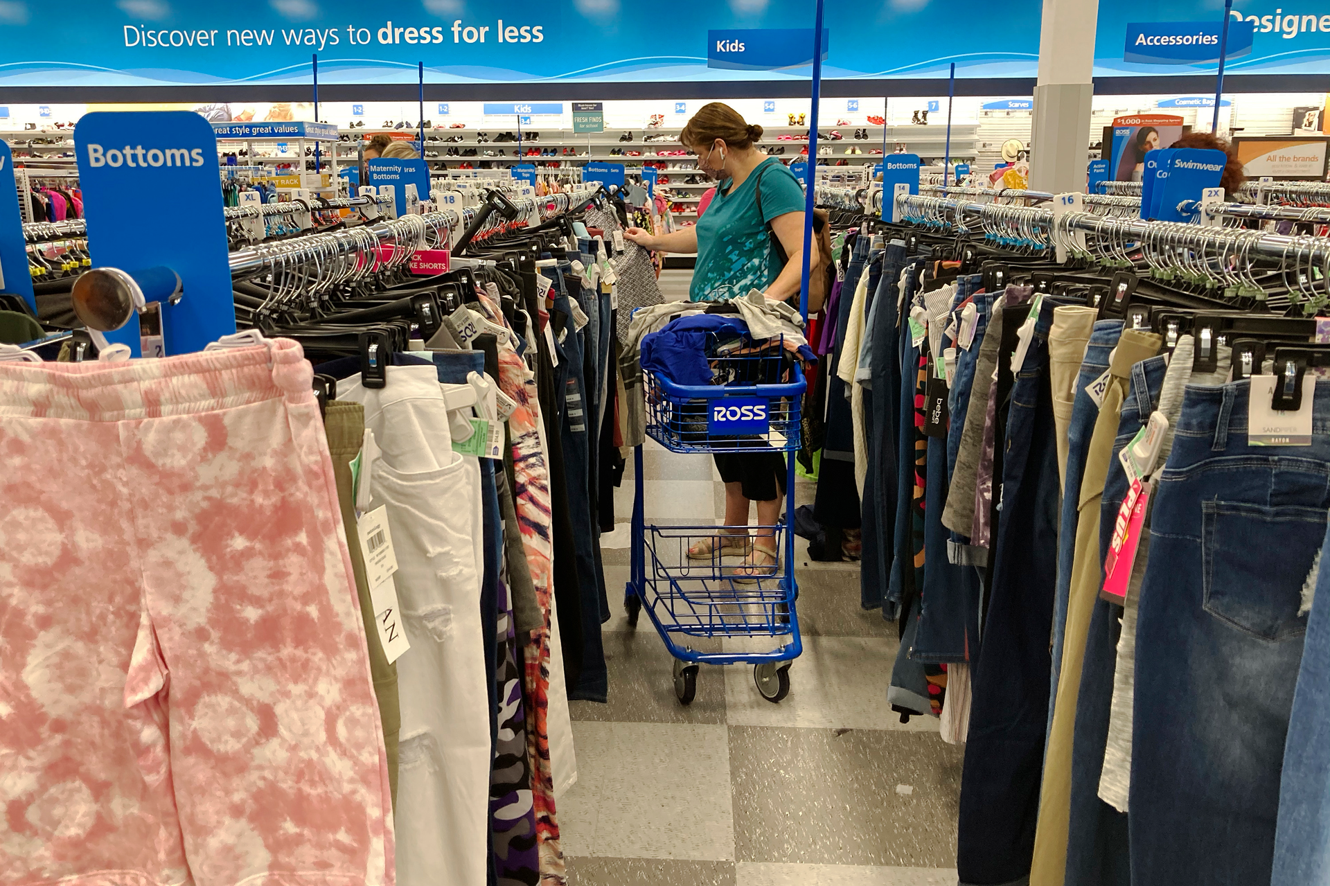 In this July 21,2021 photo, a consumer shops at a retail store in Morton Grove, Ill. U.S. consumer spending accelerated in August despite the surge in COVID cases, while the additional demand combined with supply shortages kept inflation high.