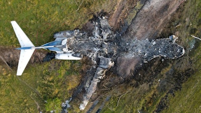 The remnants of an aircraft, which caught fire soon after a failed take-off attempt at Houston Executive Airport, are seen just north of Morton Road on Tuesday, Oct. 19, 2021, in Brookshire. Texas.