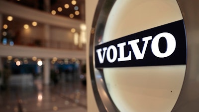 This Feb. 6, 2020, file photo shows the Volvo logo in the lobby of the Volvo corporate headquarters in Brussels. Swedish automaker Volvo said Monday, Oct. 4,2021 it plans to raise at least 25 billion kroner ($2.9 billion) by selling shares to fund its electric vehicle transformation strategy. Volvo and its parent company, Chinese carmaker Geely, have applied to hold an initial public offering on the Nasdaq Stockholm.