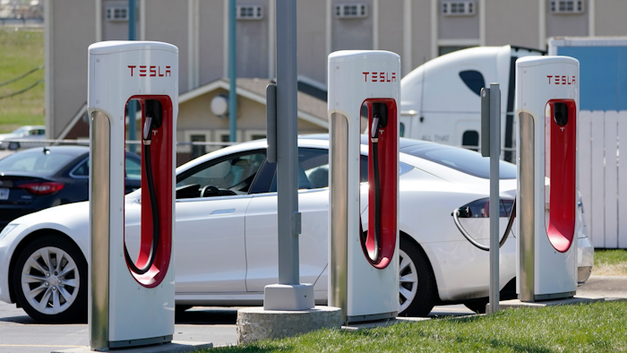 A Tesla charges at a station in Topeka, Kan., April 5, 2021. President Joe Biden and Democrats in Congress are looking to give U.S. automakers with union employees the inside track when it comes to winning the burgeoning electric vehicle market.