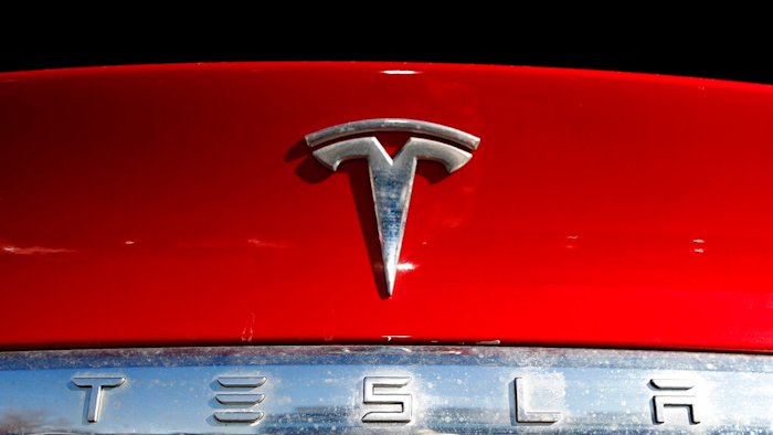 The Tesla company logo sits on an unsold 2020 Model X at a Tesla dealership in Littleton, Colo., on Feb. 2, 2020. Tesla has issued a recall that will automatically send a software update fixing a safety problem in its electric vehicles. The recall on Tuesday, Nov. 2, 2021, apparently heads off a looming confrontation with U.S. safety regulators.