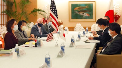 U.S. Commerce Secretary Gina Raimondo, left, talks with Japanese Foreign Minister Yoshimasa Hayashi, right, during their meeting in Tokyo on Nov. 15, 2021.