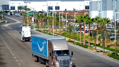 A semi-truck turns into an Amazon Fulfillment center in Eastvale, CA on Nov. 12, 2020.