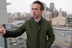 Des Moines Downtown Neighborhood Association president Brandon Brown stands on the roof of his condo building, Friday, Nov. 12, 2021, in Des Moines, Iowa. After decades of downplaying or simply ignoring the problem, Des Moines officials here recently began a comprehensive study that will lead to tighter regulations on some smelly manufacturing plants near downtown.