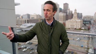 Des Moines Downtown Neighborhood Association president Brandon Brown stands on the roof of his condo building, Friday, Nov. 12, 2021, in Des Moines, Iowa. After decades of downplaying or simply ignoring the problem, Des Moines officials here recently began a comprehensive study that will lead to tighter regulations on some smelly manufacturing plants near downtown.