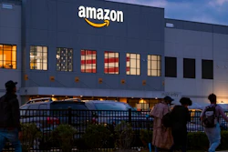 People arrive for work at the Amazon distribution center in the Staten Island borough of New York, Monday, Oct. 25, 2021. The National Labor Relations Board is confirming that a group of Amazon warehouse workers in Staten Island, New York has withdrawn its petition to hold a vote to unionize its workers.