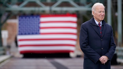 President Joe Biden waits to speak during a visit to the NH 175 bridge over the Pemigewasset River to promote infrastructure spending Tuesday, Nov. 16, 2021, in Woodstock, N.H.