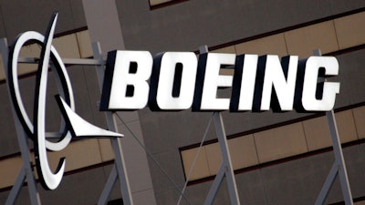The Boeing Company logo is seen on the property in El Segundo, Calif., Tuesday, Jan. 25, 2011. Insurers for several current and former Boeing board members will pay more than $230 million to settle a lawsuit that accused the directors of failing to address safety warning signs before two of the company’s Max jetliners crashed.