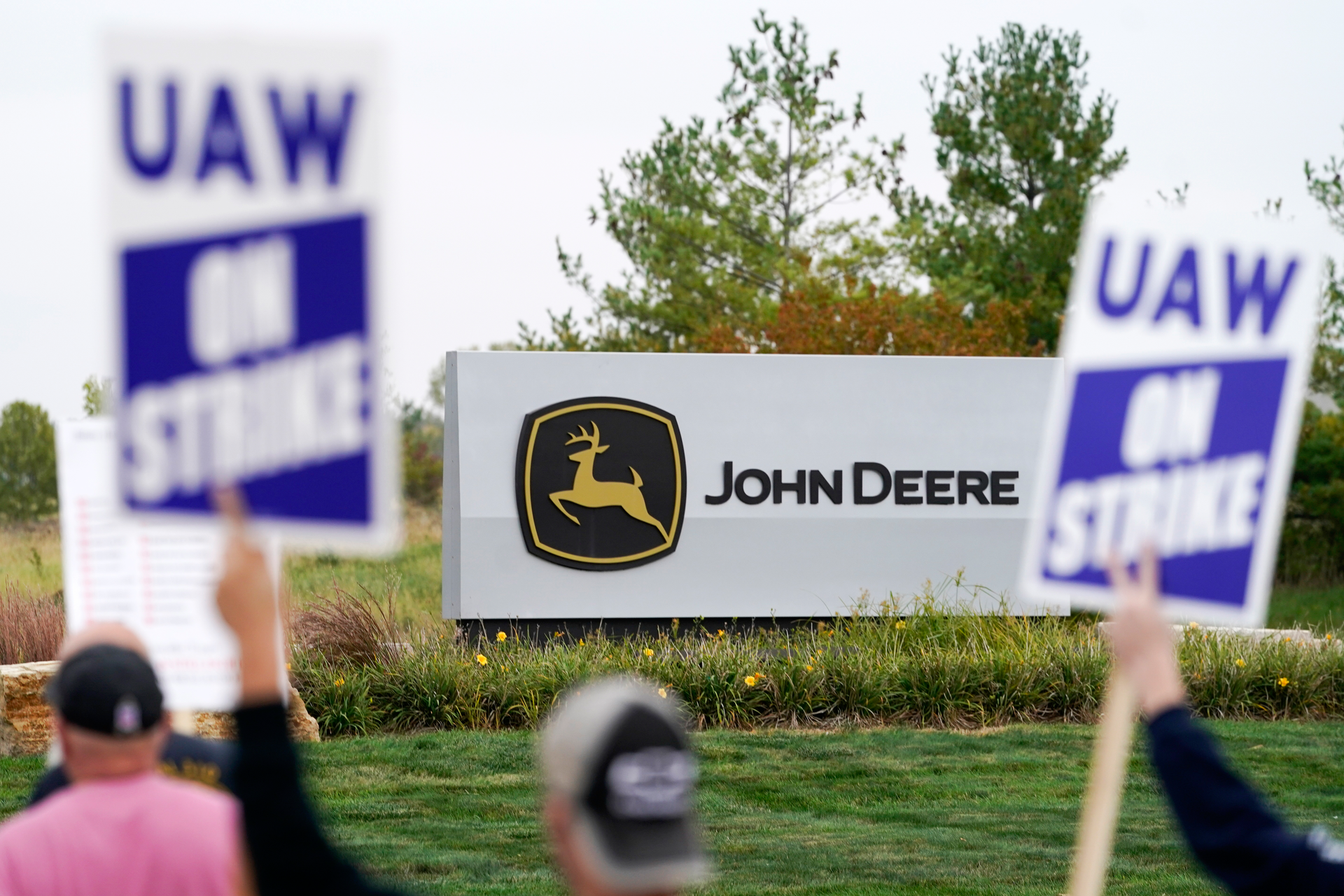 Members of the United Auto Workers strike outside of a John Deere plant, Wednesday, Oct. 20, 2021, in Ankeny, Iowa.