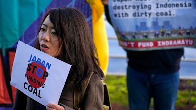 Activists protest against Japan's support of the coal industry near the COP26 U.N. Climate Summit in Glasgow, Scotland, Thursday, Nov. 4, 2021. The U.N. climate summit in Glasgow gathers leaders from around the world, in Scotland's biggest city, to lay out their vision for addressing the common challenge of global warming.