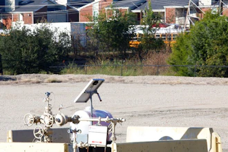 A natural gas well is juxtaposed with apartment buildings a few hundred feet away in Arlington, Texas, on Monday, Oct. 25, 2021. The site, known as 'AC-360,' is operated by TEP Barnett, a subsidiary of French energy giant Total Energies. It is one of Total's 33 well sites in Arlington that contain 163 wells. The company has proposed adding three new wells at this site. Some residents of the predominately Hispanic and Black neighborhood, as well as parents and staff at a daycare near the site, oppose the plan, citing health concerns.