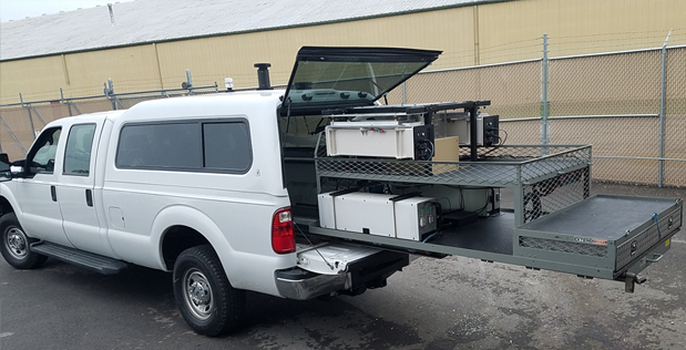 SIGMA+ sensors detecting the entire spectrum of weapons of mass destruction (WMD) threats slide into the back of a police vehicle with additional space on the racks for regular police cargo.