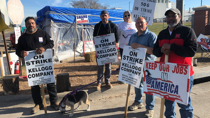Striking Kellogg's workers Michael Rodarte, Sue Griffin, Michael Elliott, Eric Bates and Mark Gonzalez stand outside the Omaha, Neb., cereal plant, Dec. 2, 2021.